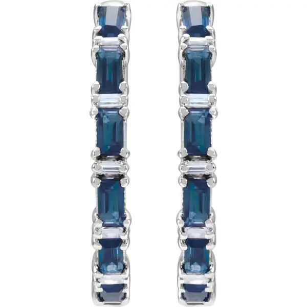 Pair of 14k white gold sapphire hoop earrings, measuring 2 mm thick, with fourteen GIA Type II Clarity AA, round brilliant cut sapphires. The sapphires have a total weight of 1.26 carats, and are prong set. In addition, there are twelve baguette diamonds, G-H color, I1 clarity, with a total weight of 1.25 carats.