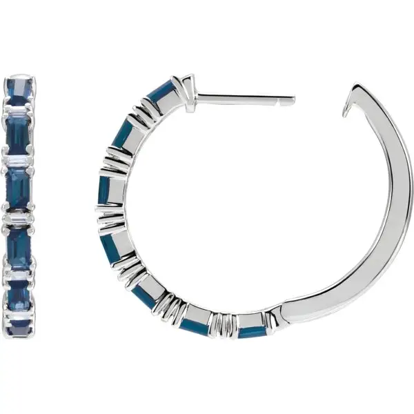 Pair of 14k white gold sapphire hoop earrings, measuring 2 mm thick, with fourteen GIA Type II Clarity AA, round brilliant cut sapphires. The sapphires have a total weight of 1.26 carats, and are prong set. In addition, there are twelve baguette diamonds, G-H color, I1 clarity, with a total weight of 1.25 carats.