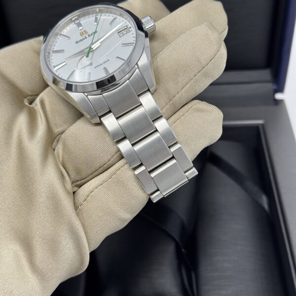 Angled view of Grand Seiko SBGA427 showing brushed bracelet and polished case edges