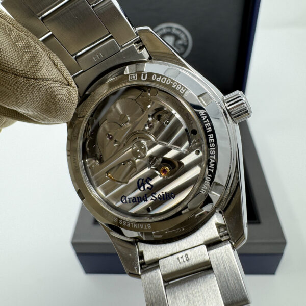 Close-up of Grand Seiko SBGA427 exhibition caseback showing decorated movement and engraved rotor