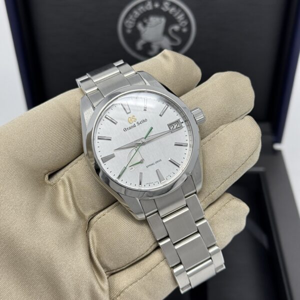 Another front view of Grand Seiko SBGA427 highlighting the silver dial and date display