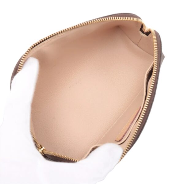 Interior view showing the light beige leather lining of the pouch, with a clean open compartment and soft texture.
