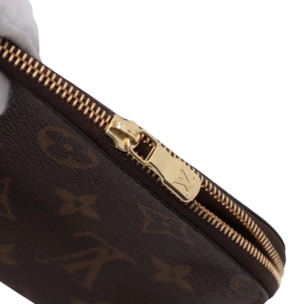 Close-up of the gold-tone zipper with LV logo pull, highlighting clean hardware and monogram canvas trim.
