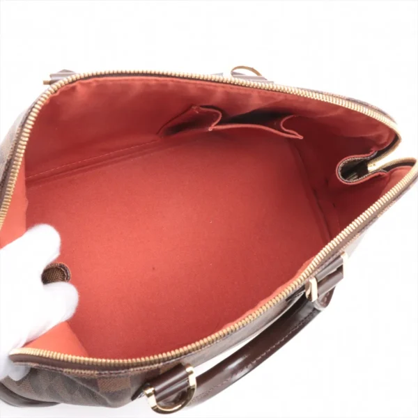 Wide interior view showing the red lining, flat base, and slip pocket compartments inside the bag.