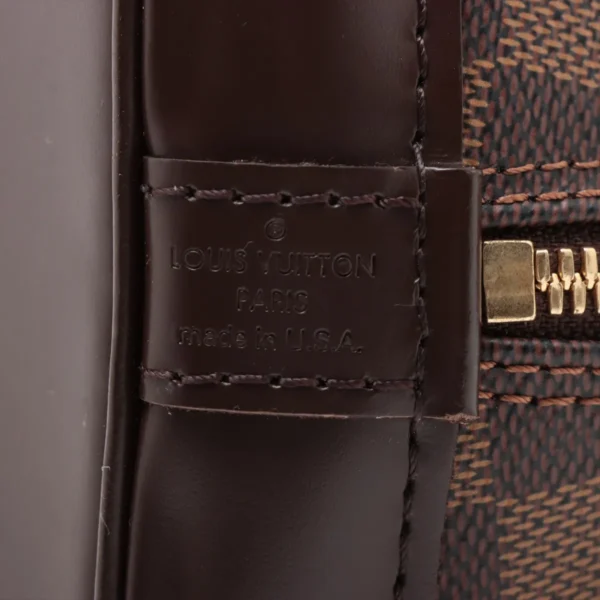 Close-up of embossed Louis Vuitton Paris stamp on brown leather tab, marked “Made in U.S.A.”