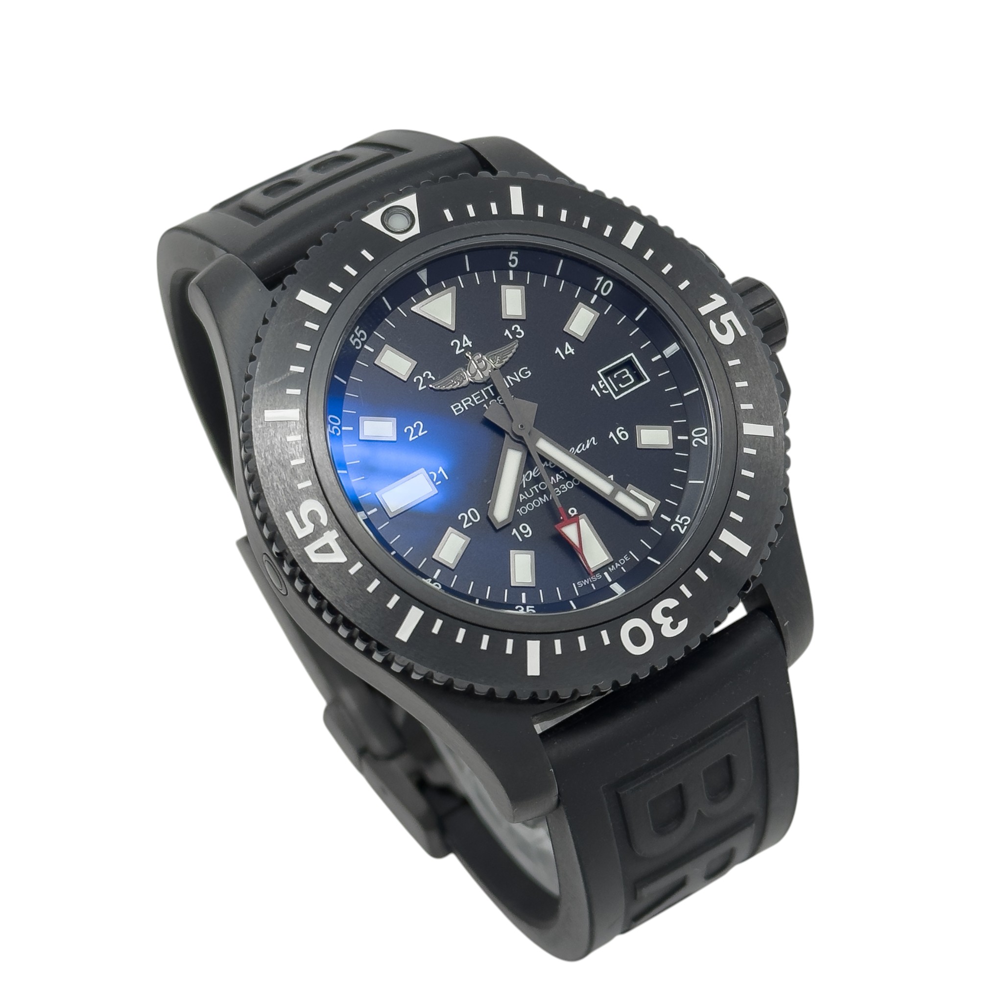 Black dive watch with rotating bezel, blue dial, luminous hands and markers, and textured black rubber strap.