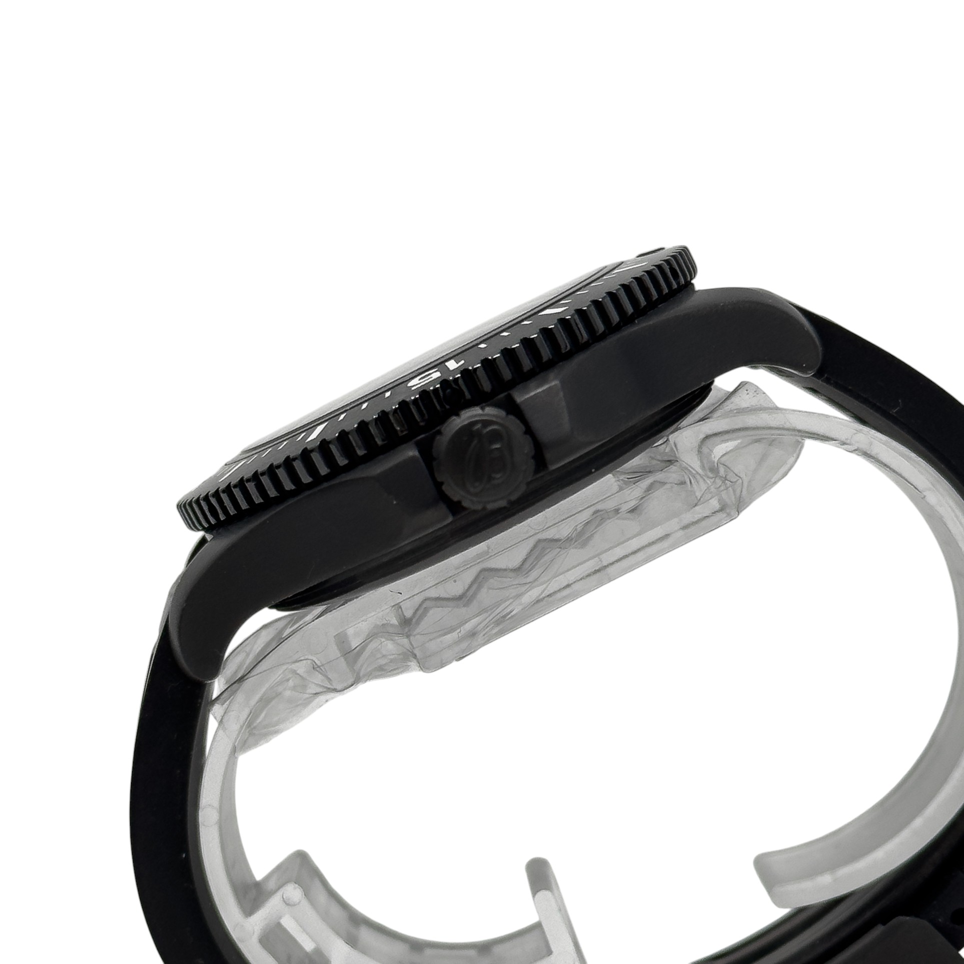 Close-up side view of a black watch case and serrated bezel with crown and part of the translucent strap insert.