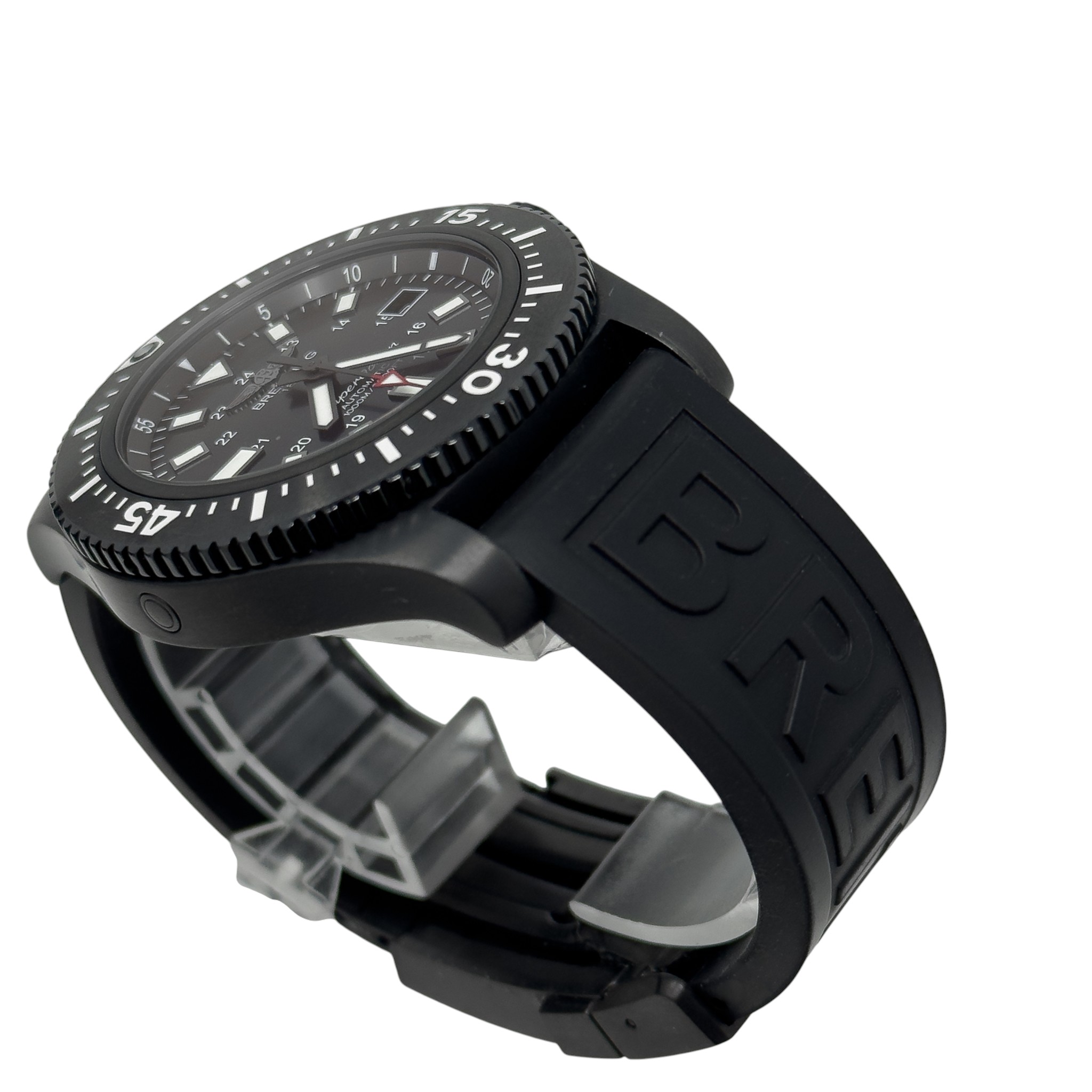 Black dive watch with rotating bezel, luminous markers, and textured black rubber strap on a clear display stand.