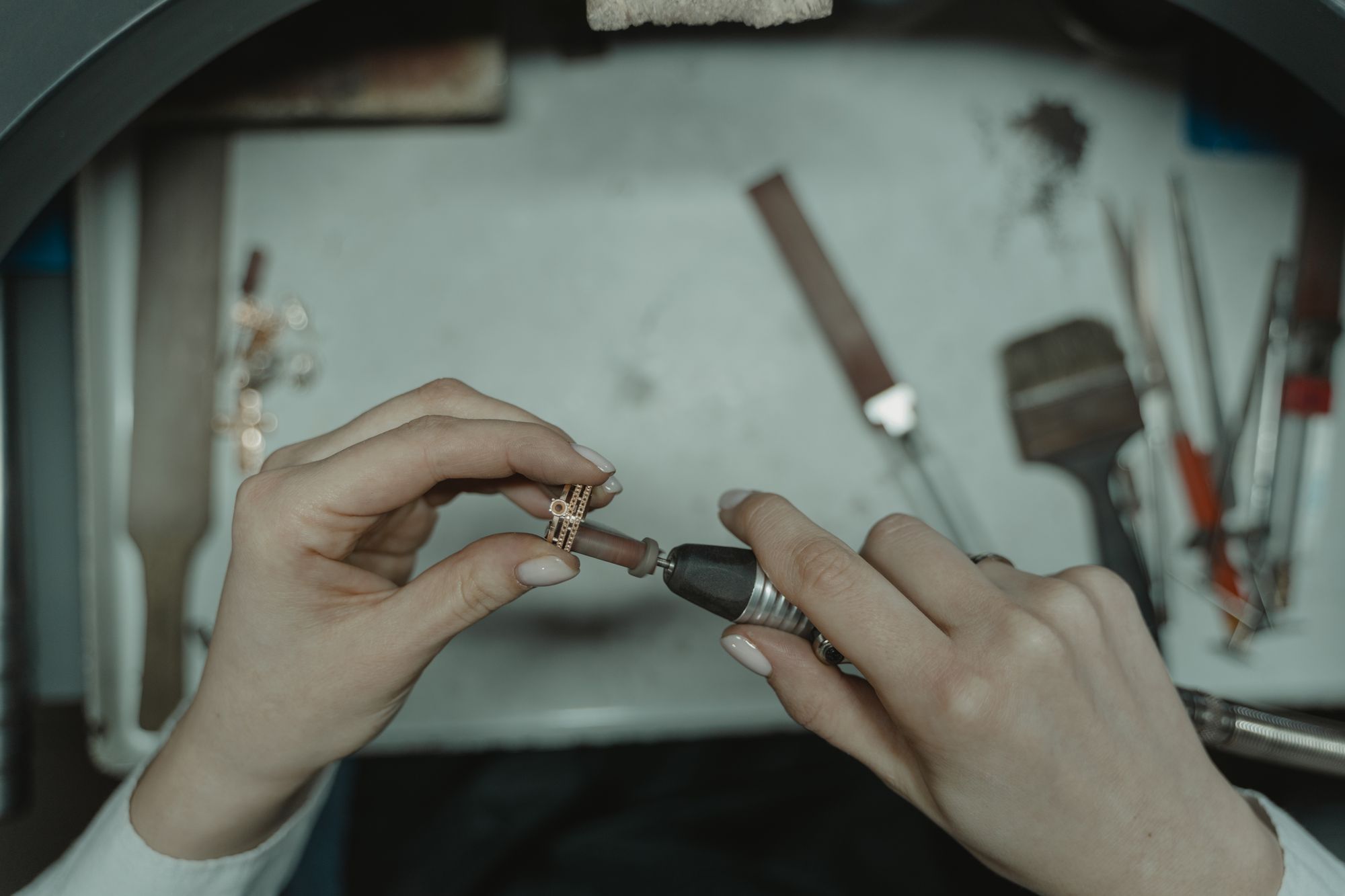 Jeweler polishing a ring at the workbench